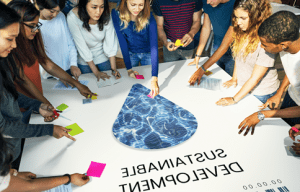 Paul Smith's students with their hands on a poster showing the words 